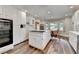 Bright kitchen features wood floors, a central island with gas cooktop, and stainless steel appliances at 5335 Bannergate Dr, Johns Creek, GA 30022