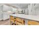 Bright kitchen features white cabinetry, stone countertops, stainless appliances and a breakfast bar at 5335 Bannergate Dr, Johns Creek, GA 30022