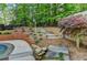 Landscaped backyard with a stone walkway leading to an upper tier at 5335 Bannergate Dr, Johns Creek, GA 30022