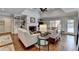 Bright living room with hardwood floors, built-in bookshelves, and a cozy fireplace at 5335 Bannergate Dr, Johns Creek, GA 30022