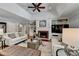 Cozy living room features a brick fireplace, hardwood floors, custom built-ins, and vaulted ceilings at 5335 Bannergate Dr, Johns Creek, GA 30022
