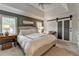 A main bedroom with gray walls, a ceiling fan, and white sliding barn doors at 5335 Bannergate Dr, Johns Creek, GA 30022