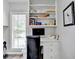 Bright office nook featuring built in shelves, white cabinets, and a window at 5335 Bannergate Dr, Johns Creek, GA 30022