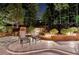 Outdoor patio featuring stone pavers, mature trees, and ambient lighting at 5335 Bannergate Dr, Johns Creek, GA 30022