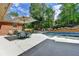 Outdoor patio featuring a dining table with an umbrella, with a beautiful pool and landscape at 5335 Bannergate Dr, Johns Creek, GA 30022