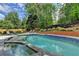 Beautiful in-ground swimming pool with lush landscaping at 5335 Bannergate Dr, Johns Creek, GA 30022