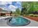 Backyard pool area with lush landscaping and a brick pool wall at 5335 Bannergate Dr, Johns Creek, GA 30022