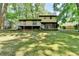 Exterior view of the back of the home with deck and green grass at 6419 Danbury Ln, Norcross, GA 30093