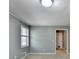 This is a bedroom with neutral carpet, light gray walls, and natural light from a window at 6419 Danbury Ln, Norcross, GA 30093