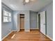 A well-lit bedroom showcases hardwood floors, blue walls, and a convenient closet space at 6419 Danbury Ln, Norcross, GA 30093