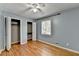 Well lit bedroom with hardwood flooring, closet with bi-fold doors, and a ceiling fan at 6419 Danbury Ln, Norcross, GA 30093