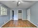 Comfortable bedroom with hardwood floors, blue walls, a window, and closet space at 6419 Danbury Ln, Norcross, GA 30093