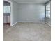 This is a large bedroom with neutral carpet, light gray walls, and a doorway to another room at 6419 Danbury Ln, Norcross, GA 30093