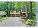 Charming two-story home with brick and siding, a two-car garage, and surrounded by mature trees at 6419 Danbury Ln, Norcross, GA 30093