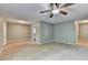 Spacious living room featuring a ceiling fan, neutral paint, and wall to wall carpeting at 6419 Danbury Ln, Norcross, GA 30093