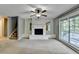 Living room boasts a brick fireplace, large window, and ceiling fan, creating a cozy and inviting atmosphere at 6419 Danbury Ln, Norcross, GA 30093