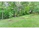 Expansive backyard with lush green lawn and mature trees, offering privacy and tranquility at 478 Guilford Cir, Marietta, GA 30068