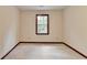 A bedroom with neutral walls and trim, featuring a window for natural light and carpeted floors at 478 Guilford Cir, Marietta, GA 30068