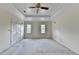 Large bedroom featuring a tray ceiling, ceiling fan, neutral paint and double windows at 478 Guilford Cir, Marietta, GA 30068