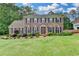 Charming two-story brick home with a manicured lawn and mature landscaping creates a welcoming curb appeal at 478 Guilford Cir, Marietta, GA 30068