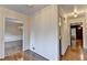 Spacious hallway with hardwood floors and neutral walls creates a seamless flow between rooms at 478 Guilford Cir, Marietta, GA 30068