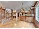 Open-concept space featuring stairs, wood-paneled walls, a kitchen area, and hardwood floors at 478 Guilford Cir, Marietta, GA 30068