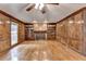 Living room boasts wood paneling, hardwood floors, built-in bookshelves, and a cozy fireplace at 478 Guilford Cir, Marietta, GA 30068