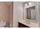 Cozy powder room with wallpaper and a dark wood vanity at 478 Guilford Cir, Marietta, GA 30068