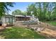 Backyard with pool, shed, fire pit, and chairs surrounded by green grass and mulch in a scenic area at 1125 Murray Sw Cir, Marietta, GA 30064