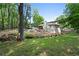 Landscaped backyard with creek bed and a covered patio provides a serene outdoor space for relaxation and entertaining at 1125 Murray Sw Cir, Marietta, GA 30064