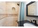 Bathroom featuring dark vanity, a shower with tan tile, and a shower niche at 1125 Murray Sw Cir, Marietta, GA 30064
