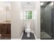 Bright bathroom features a shower with glass door and a dark wood vanity with granite counter at 1125 Murray Sw Cir, Marietta, GA 30064