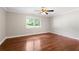 Bedroom featuring hardwood floors, neutral paint, white trim, ceiling fan, and a large window at 1125 Murray Sw Cir, Marietta, GA 30064