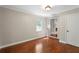 Bedroom featuring hardwood floors, neutral paint, and a doorway with a view into the living room at 1125 Murray Sw Cir, Marietta, GA 30064