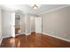 Bedroom featuring hardwood floors, neutral paint, white trim, closet, and lots of natural light at 1125 Murray Sw Cir, Marietta, GA 30064