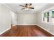 Bright bedroom boasts gleaming hardwood floors, a ceiling fan and natural light from the large window at 1125 Murray Sw Cir, Marietta, GA 30064