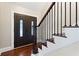 Elegant foyer showcasing the front entry door with decorative glass inserts, staircase, and hardwood floors at 1125 Murray Sw Cir, Marietta, GA 30064