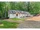 Ranch-style home featuring a crisp white painted brick exterior with modern windows and manicured landscaping at 1125 Murray Sw Cir, Marietta, GA 30064