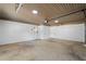 Spacious garage with overhead lighting, painted walls, and an automatic garage door at 1125 Murray Sw Cir, Marietta, GA 30064