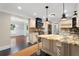 Large kitchen featuring granite countertops, island, modern appliances, and wood flooring at 1125 Murray Sw Cir, Marietta, GA 30064