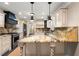 Kitchen featuring granite counters, central island, updated cabinets, and stainless appliances at 1125 Murray Sw Cir, Marietta, GA 30064