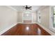 Open-concept living room featuring polished hardwood floors, neutral walls, and natural light from large windows at 1125 Murray Sw Cir, Marietta, GA 30064