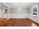 Bright living room showcasing custom wainscoting, hardwood floors, a modern light fixture, and a large window at 1125 Murray Sw Cir, Marietta, GA 30064