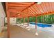 Outdoor pool area with a covered patio and scenic wooded backdrop provides relaxation and recreation at 1125 Murray Sw Cir, Marietta, GA 30064