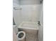 Cozy white tiled bathroom featuring a bathtub and neutral patterned flooring at 3575 Oakvale Rd # 1103, Decatur, GA 30034
