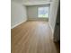 A cozy bedroom with a bright window and wood floors at 3575 Oakvale Rd # 1103, Decatur, GA 30034