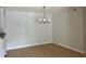 Dining area featuring laminate flooring, gray walls, and modern chandelier at 3575 Oakvale Rd # 1103, Decatur, GA 30034