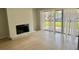 Open-concept living room with fireplace, laminate floors, and lots of natural light at 3575 Oakvale Rd # 1103, Decatur, GA 30034