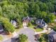 An aerial view of the home on a cul-de-sac with a manicured front lawn and professional landscaping at 417 Rhodes House Dr, Suwanee, GA 30024