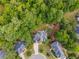 An aerial view of the home showing a large, private backyard surrounded by mature trees at 417 Rhodes House Dr, Suwanee, GA 30024
